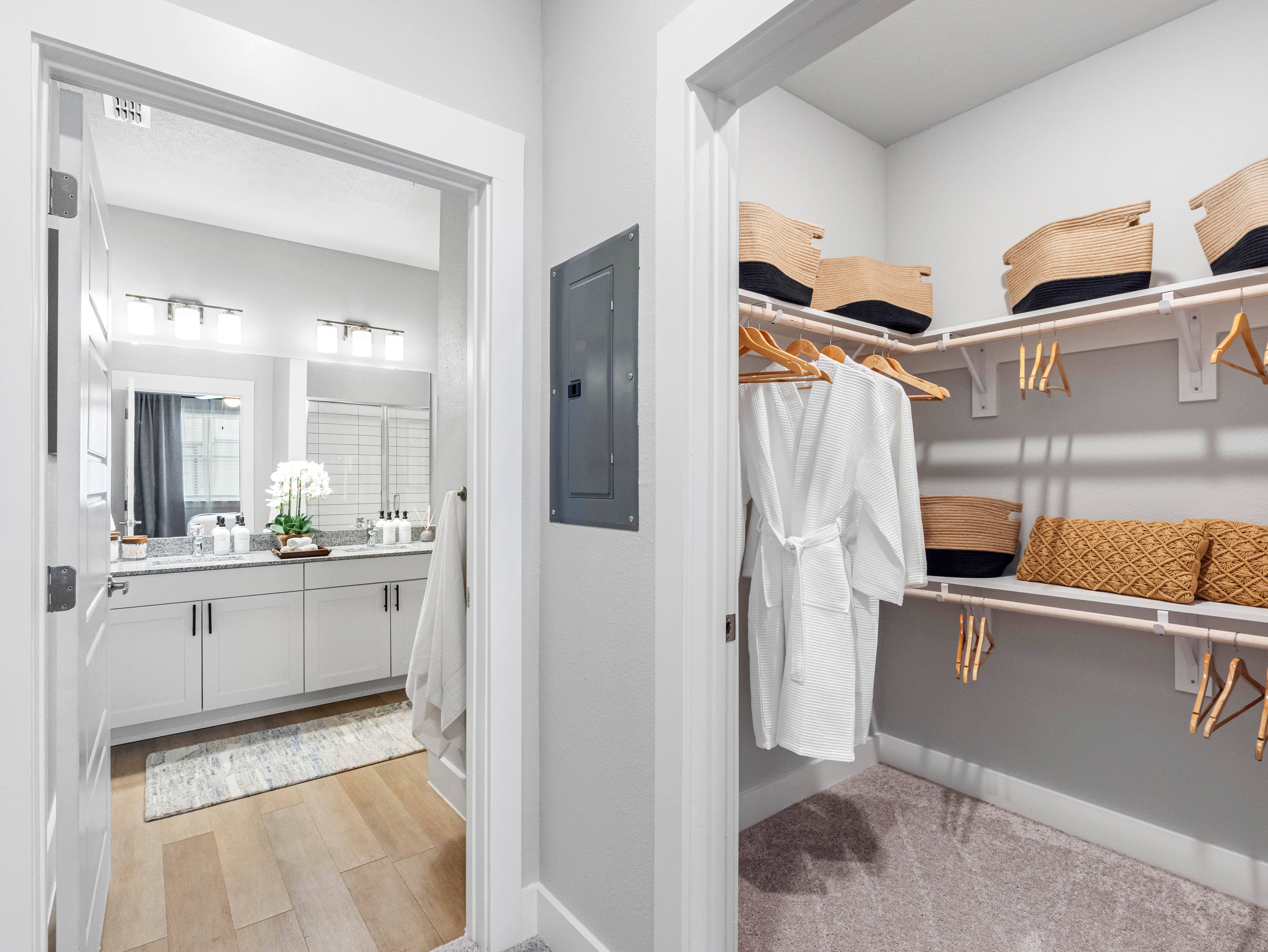 A bathroom with a white cabinet and a white towel hanging on a rack.